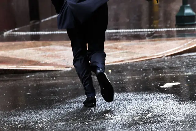 Not good shoes for the rain: Photograph of a worker in Manhattan running during a storm last year